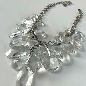 Silver tone metal fashion necklace with chunky clear stones.